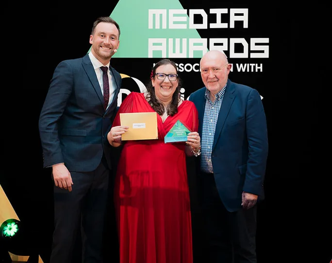 Three Absolute Digital Media colleagues on stage holding an award at a media awards ceremony