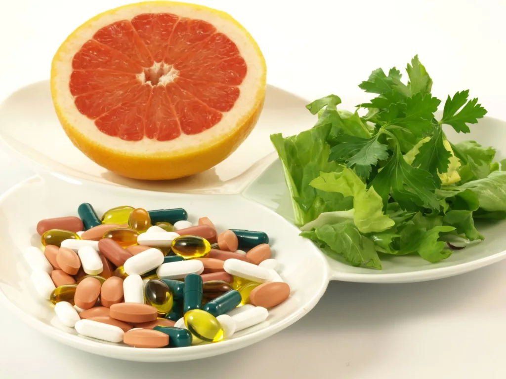 Supplements alongside fresh fruit and herbs