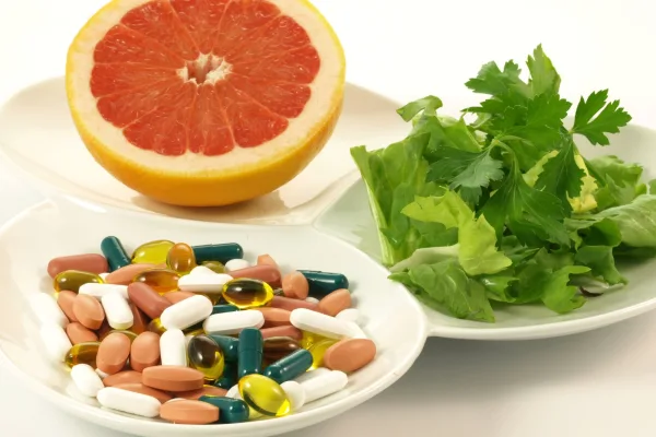 Supplements alongside fresh fruit and herbs