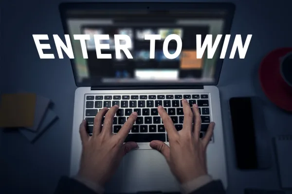 A laptop showing an “Enter to win” prize competition entry screen